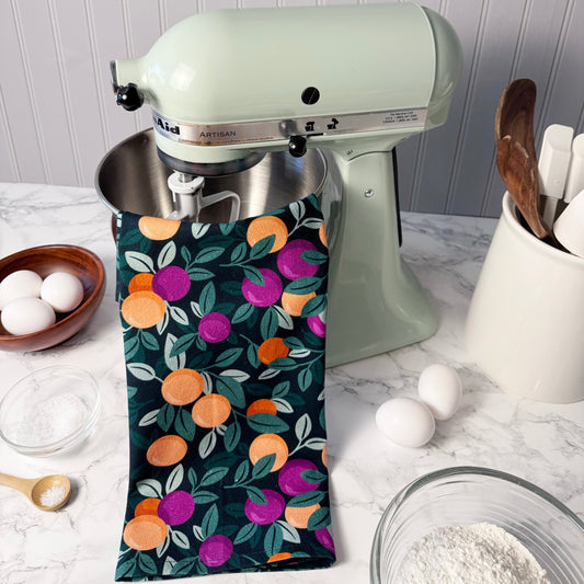 Kitchen mixer with a floral towel draped over it on a kitchen counter.