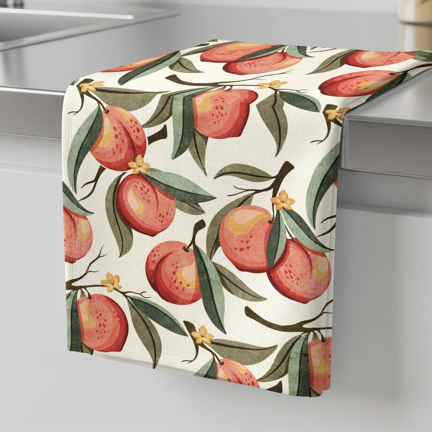 Hand-painted peach tea towel featuring ripe peaches, green leaves, and delicate blossoms on a soft cream background.