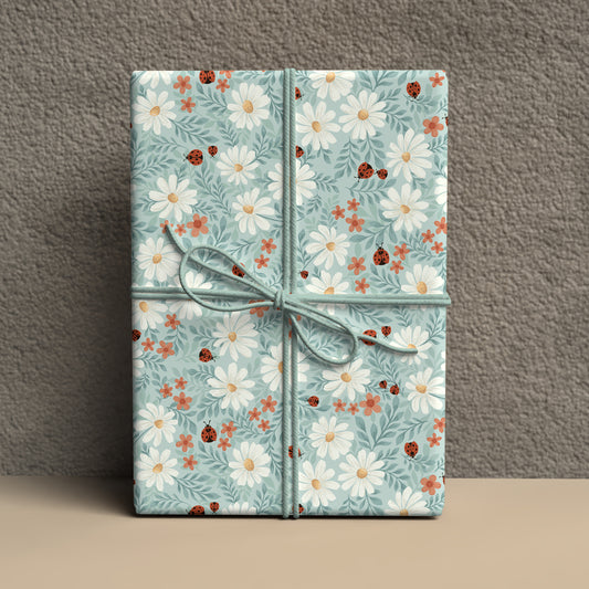 Gift box with floral pattern and ladybugs on a gray background