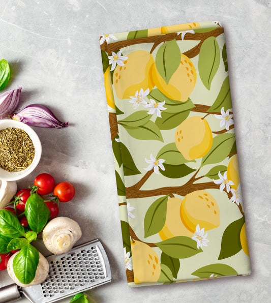 Kitchen towel with lemon pattern on a countertop with kitchen items